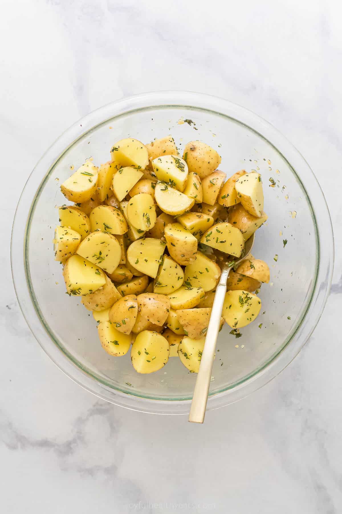 a bowl of seasoned cut up ،atoes