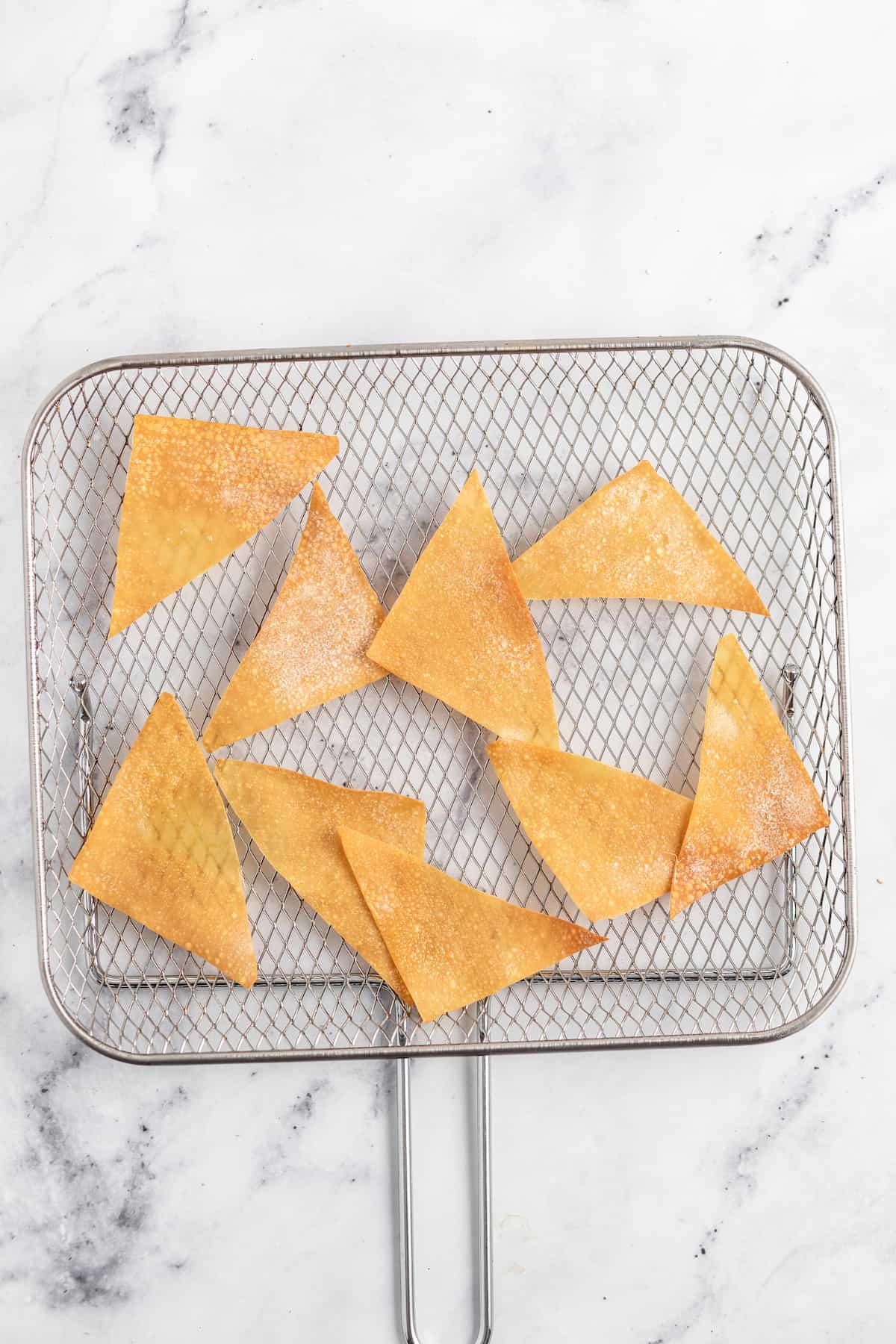 fried wonton chips on a cooling rack