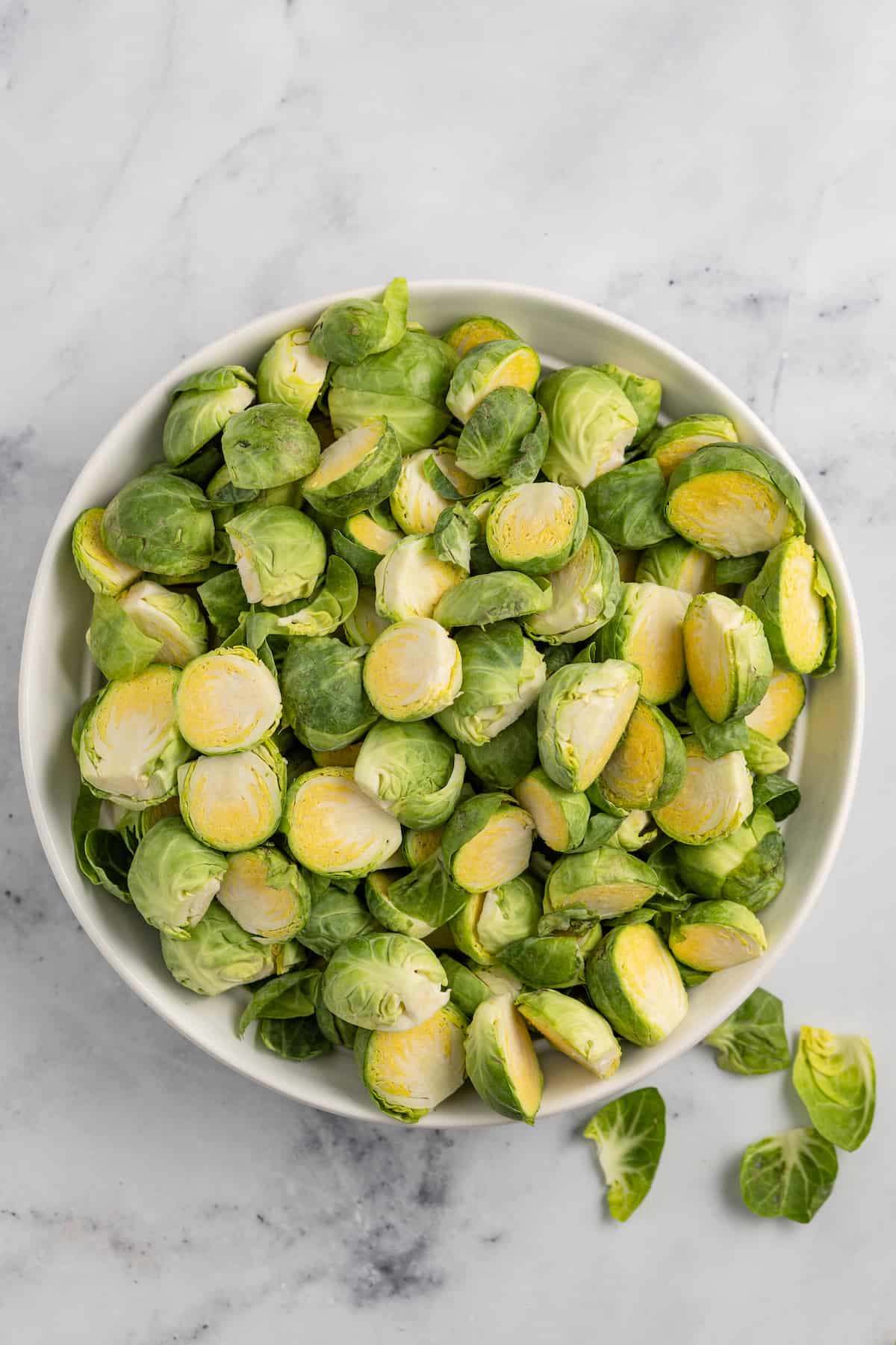 a large bowl of raw halved brussels sprouts