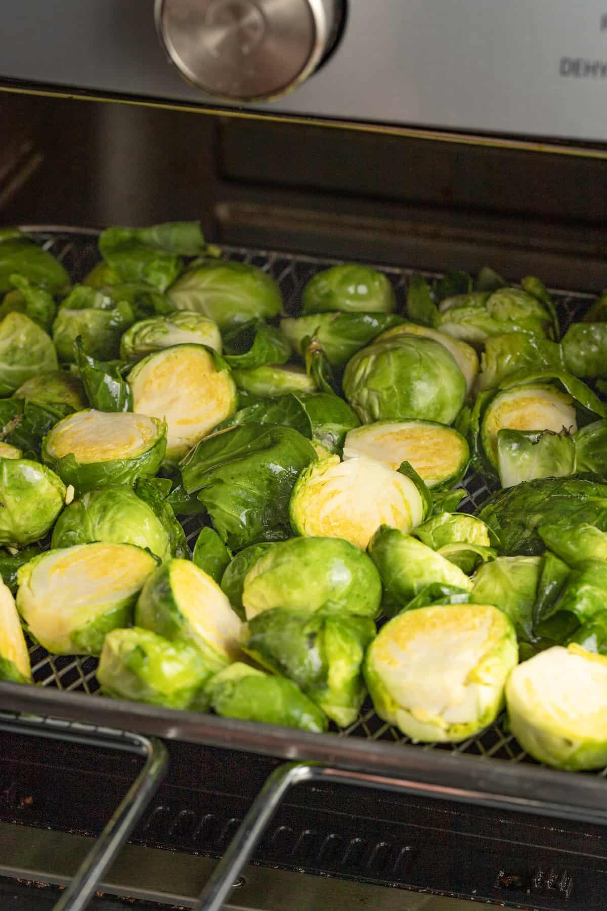 halved brussels sprouts in an air fryer tray