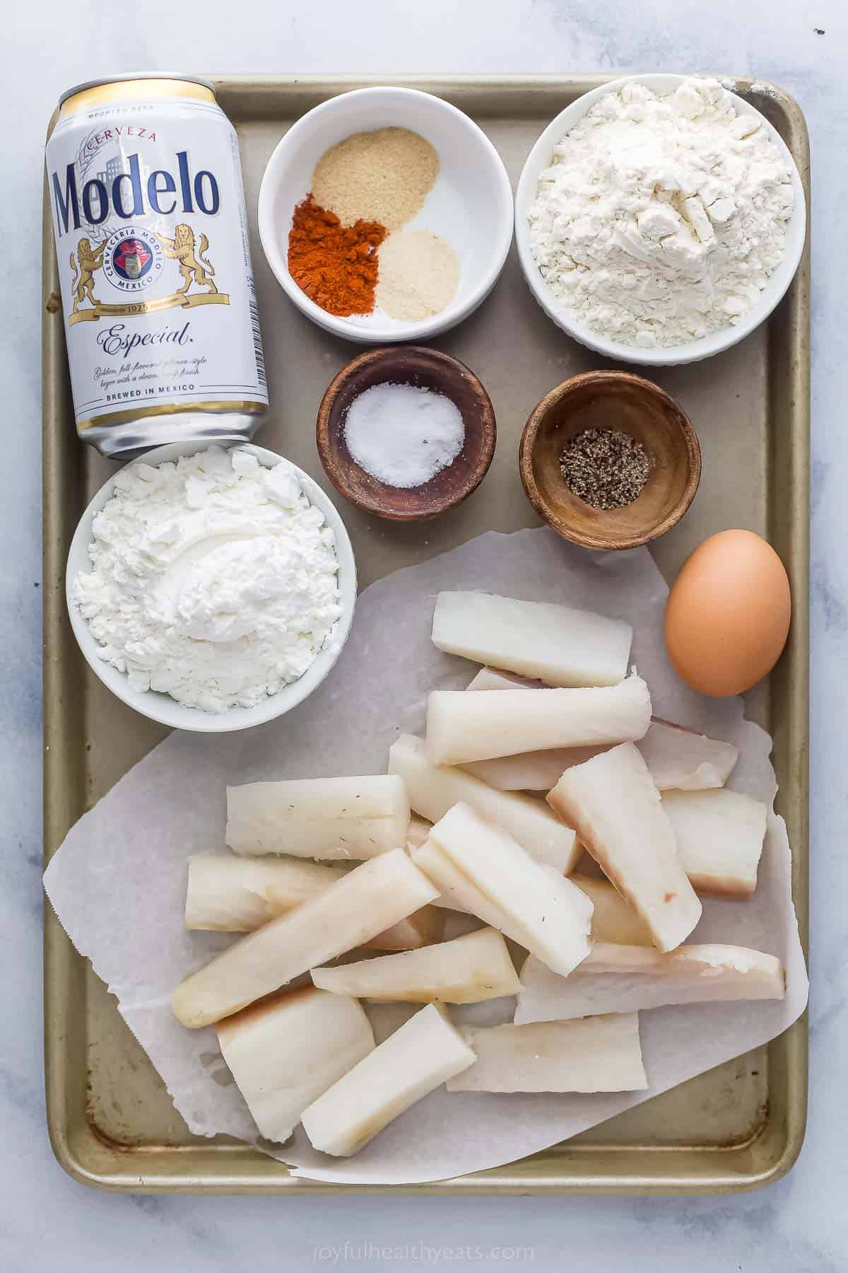 ingredients to make air fryer beer battered shrimp including fish, flour, beer, seasonings, and egg