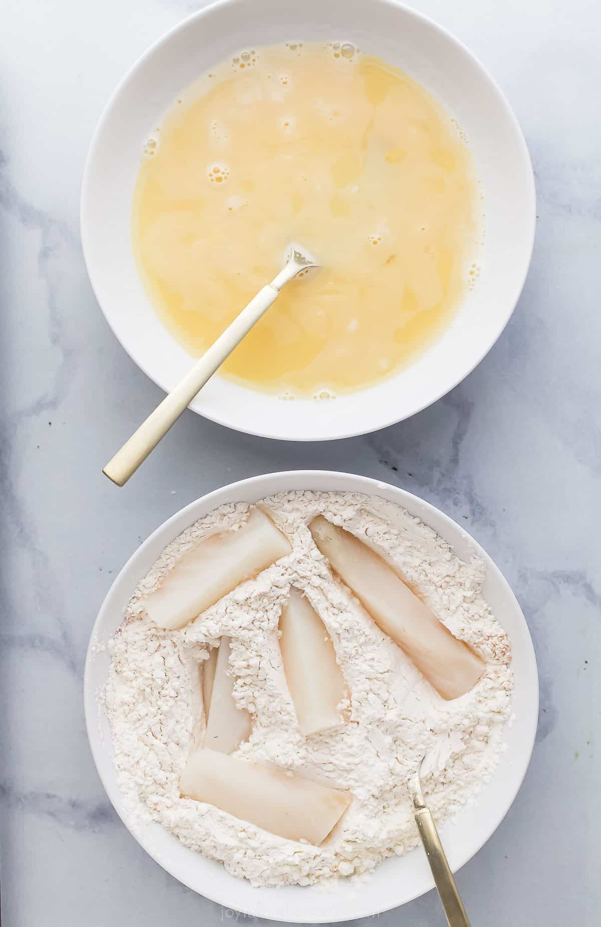 Beer Battered Air Fryer Fish Tacos are dipped in a tasty batter and fried the healthy way! Add slaw and Chipotle Crema for the perfect taco! fish sticks in a bowl with a dry mixture and another bowl of batter next to it