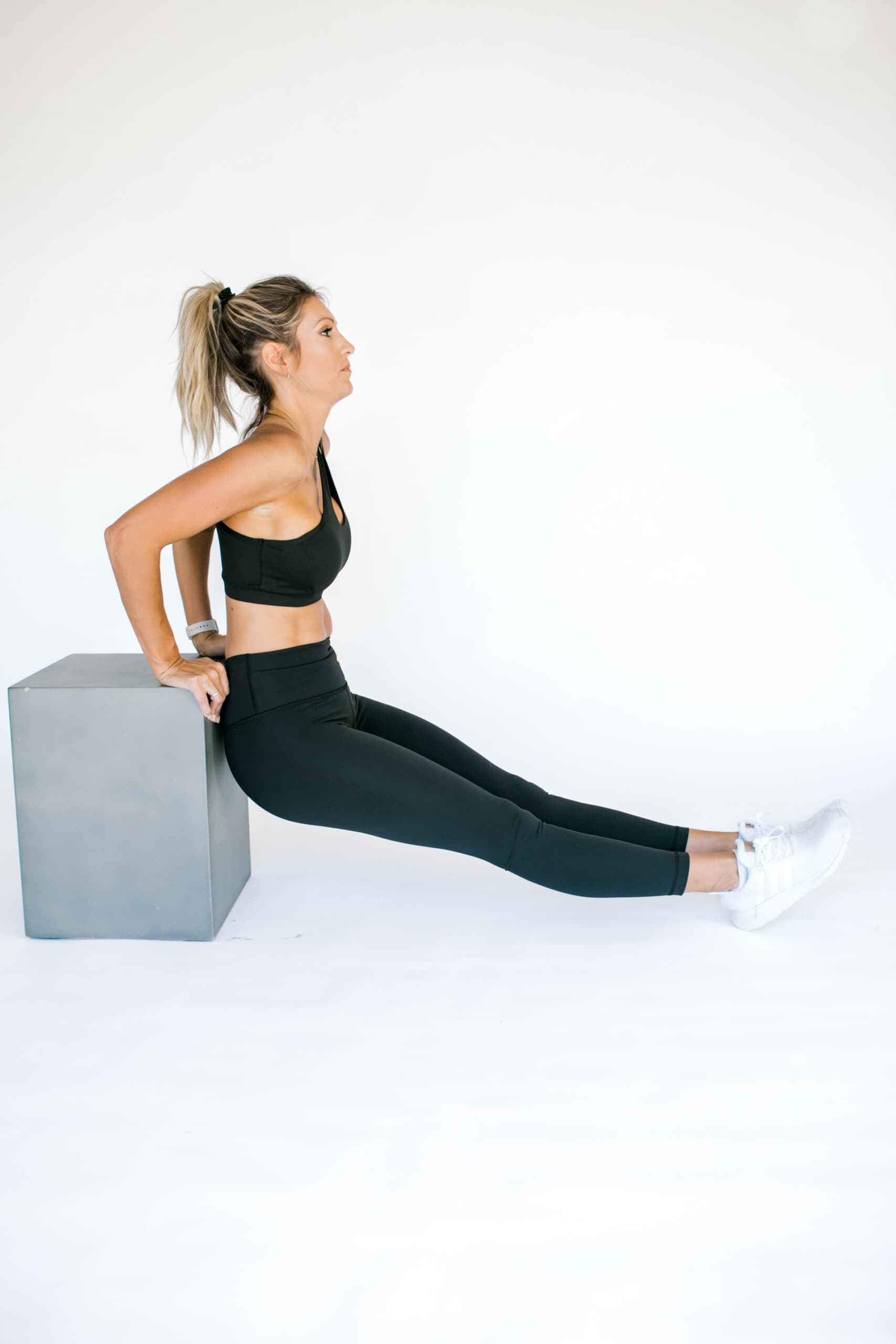 girl on a bench doing a tricep dip