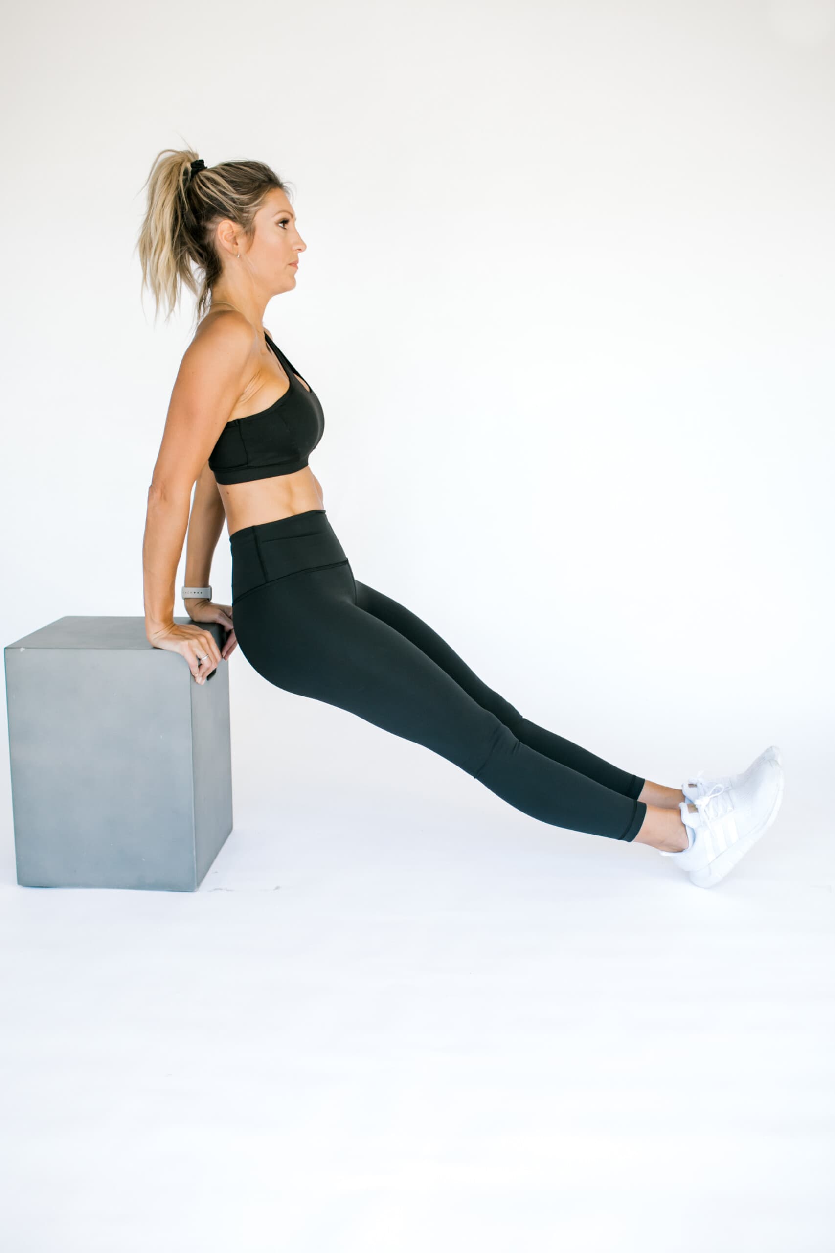 girl on a bench doing a tricep dip