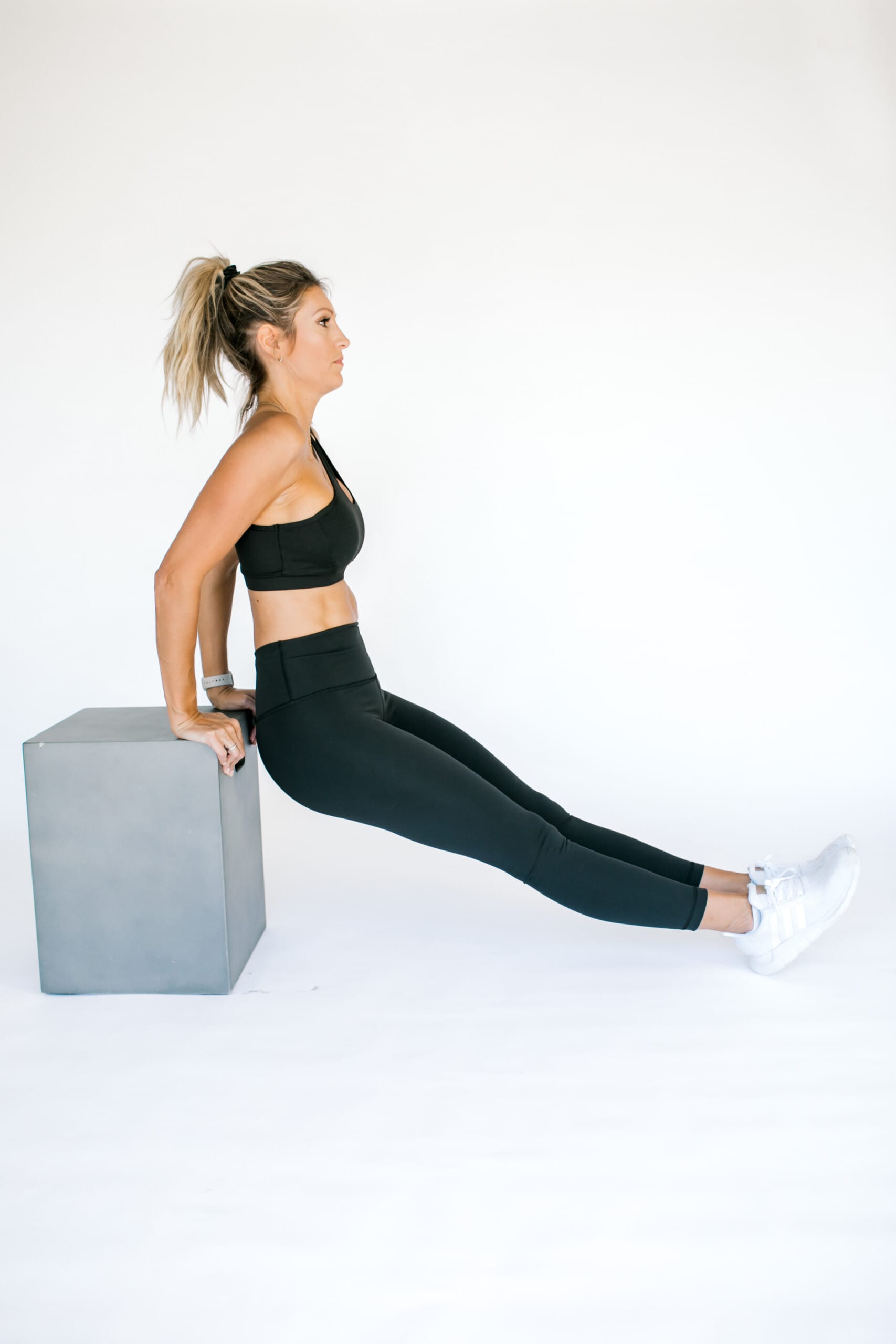 girl on a bench doing a tricep dip