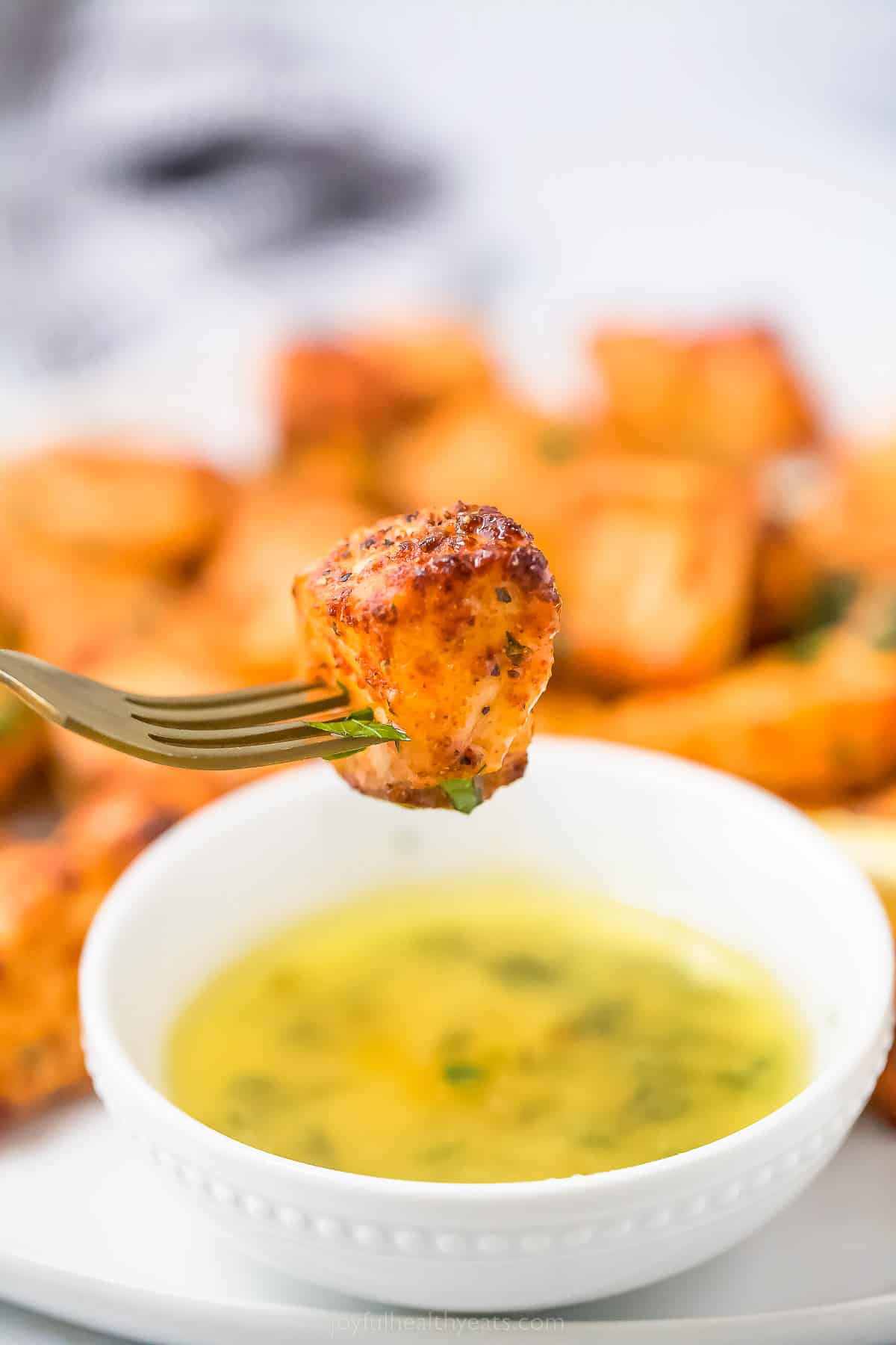 Close-up of air fryer salmon bites on a fork. 