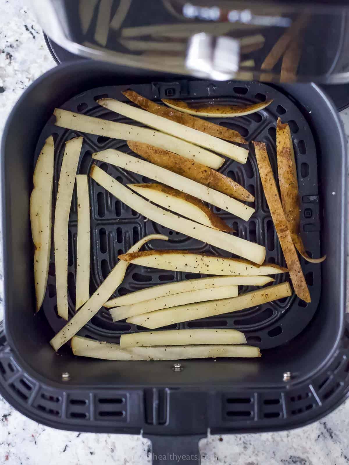 Arranging the fries in the air fryer. 