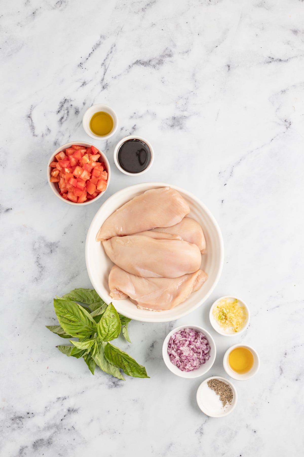 This juicy chicken bruschetta with an Italian-inspired summer veggie topping is the perfect 20-minute healthy but flavorful work lunch. Ingredients for chicken bruschetta.