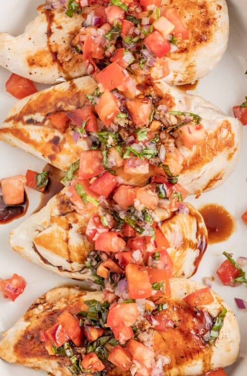 Chicken bruschetta on a plate with a drizzle of balsamic reduction.