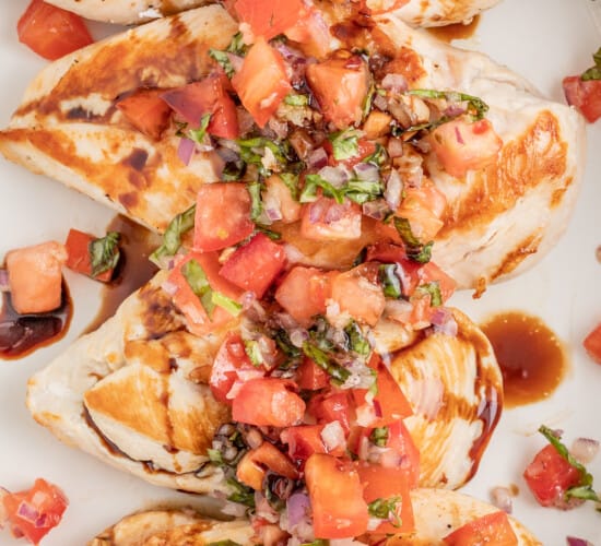 Chicken bruschetta on a plate with a drizzle of balsamic reduction.