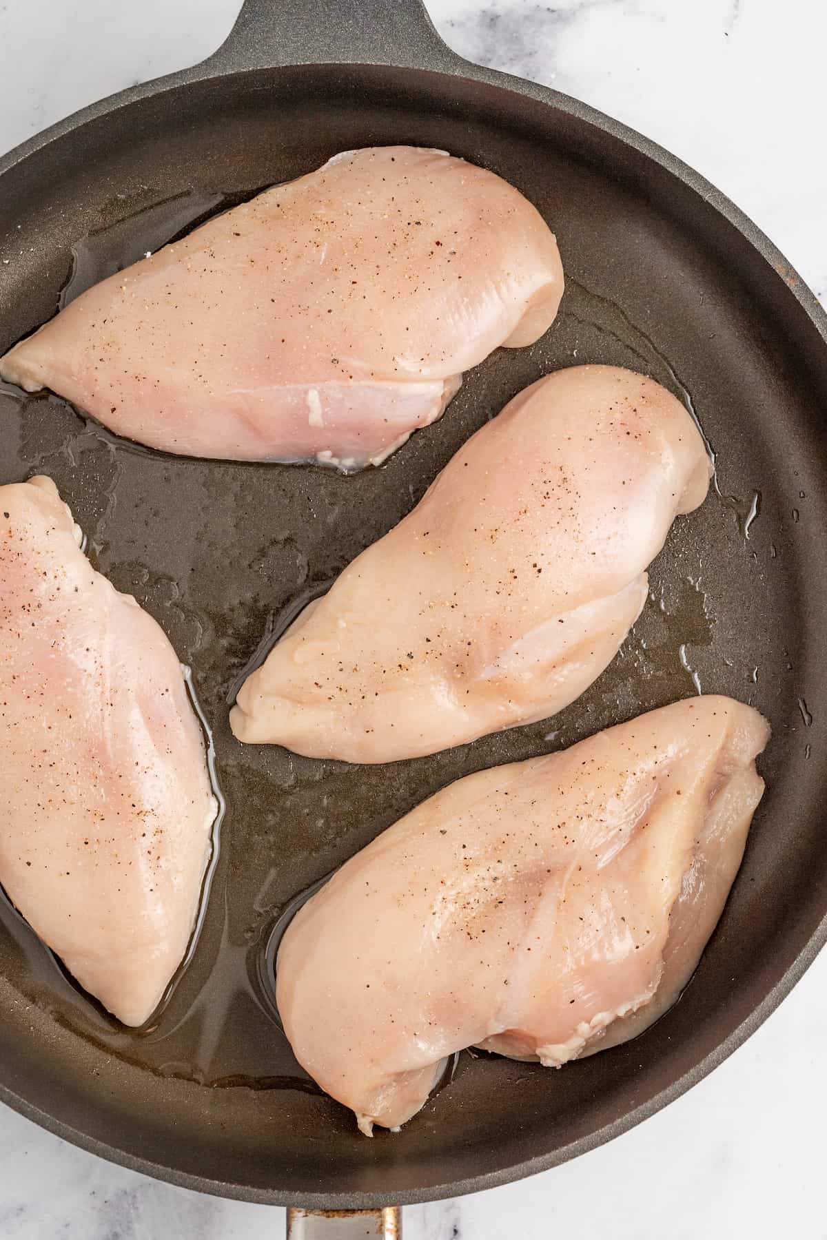 Placing the chicken in the pan.