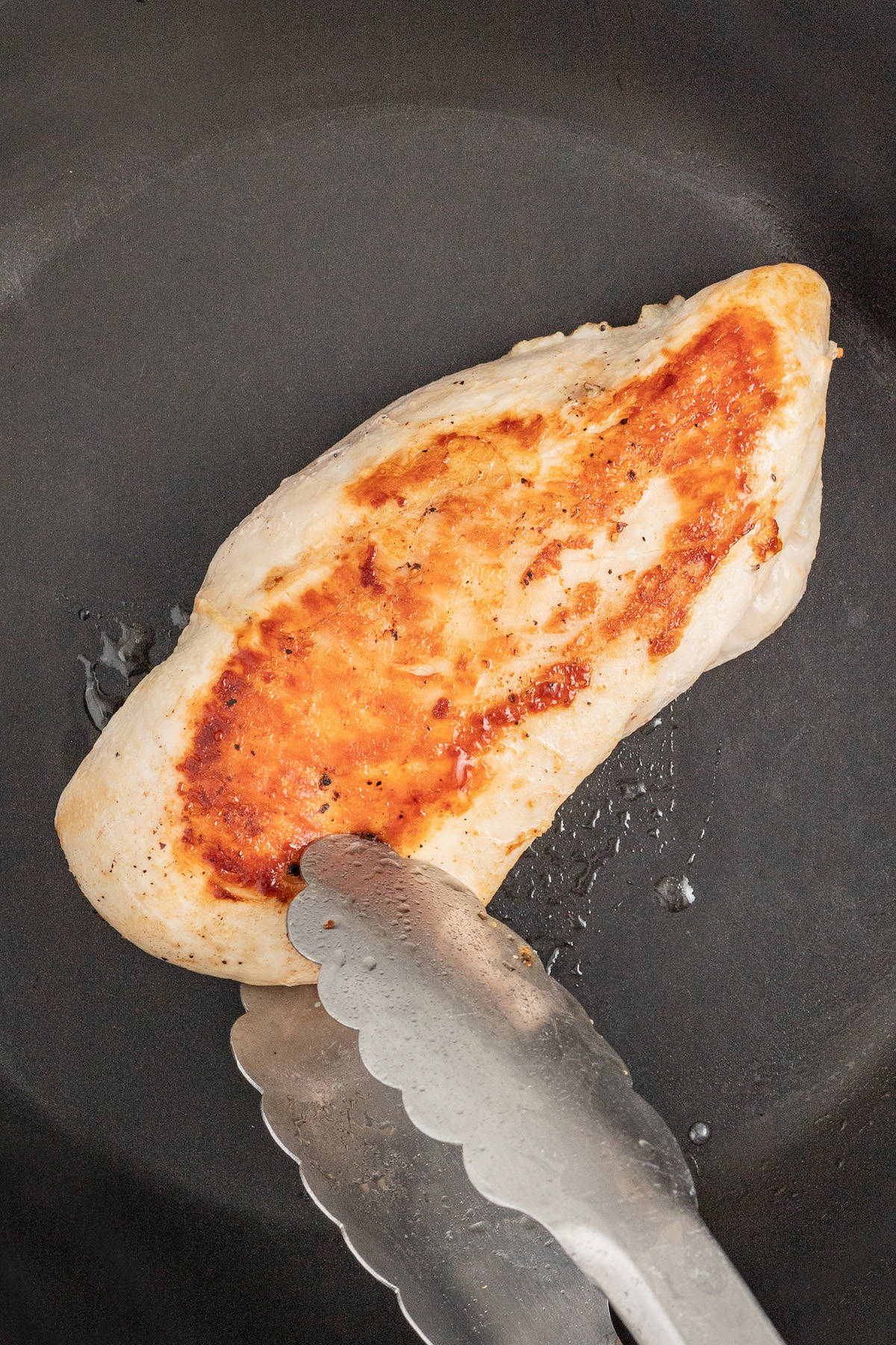 Browned chicken in the pan. 