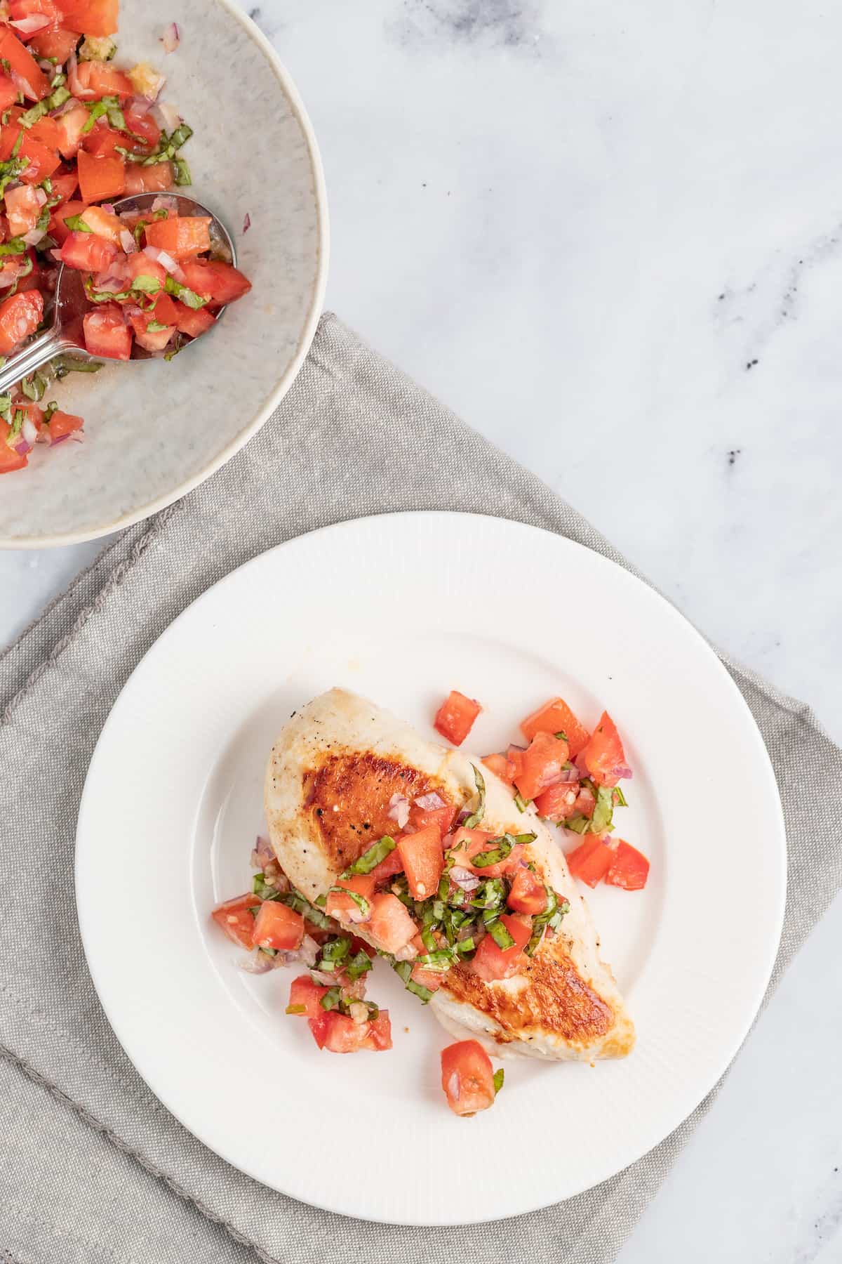 This juicy chicken bruschetta with an Italian-inspired summer veggie topping is the perfect 20-minute healthy but flavorful work lunch. Grilled chicken with the veggie mixture on top.