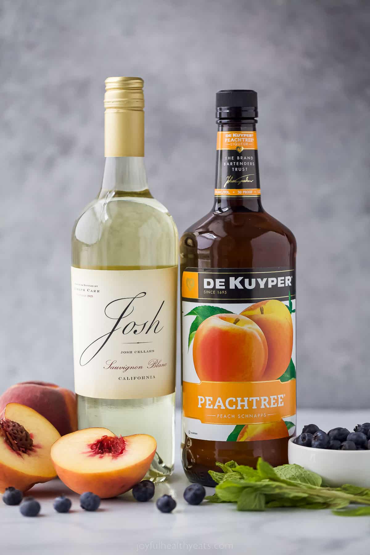 This icy peach sangria with blueberries, peach Schnapps, and mint is the fruity cocktail you'll be sipping on all summer. Ingredients for peach sangria.