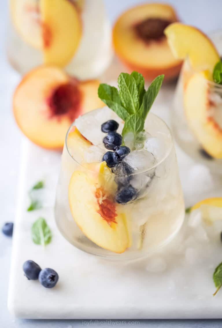 Peach sangria with mint in a crystal glass.