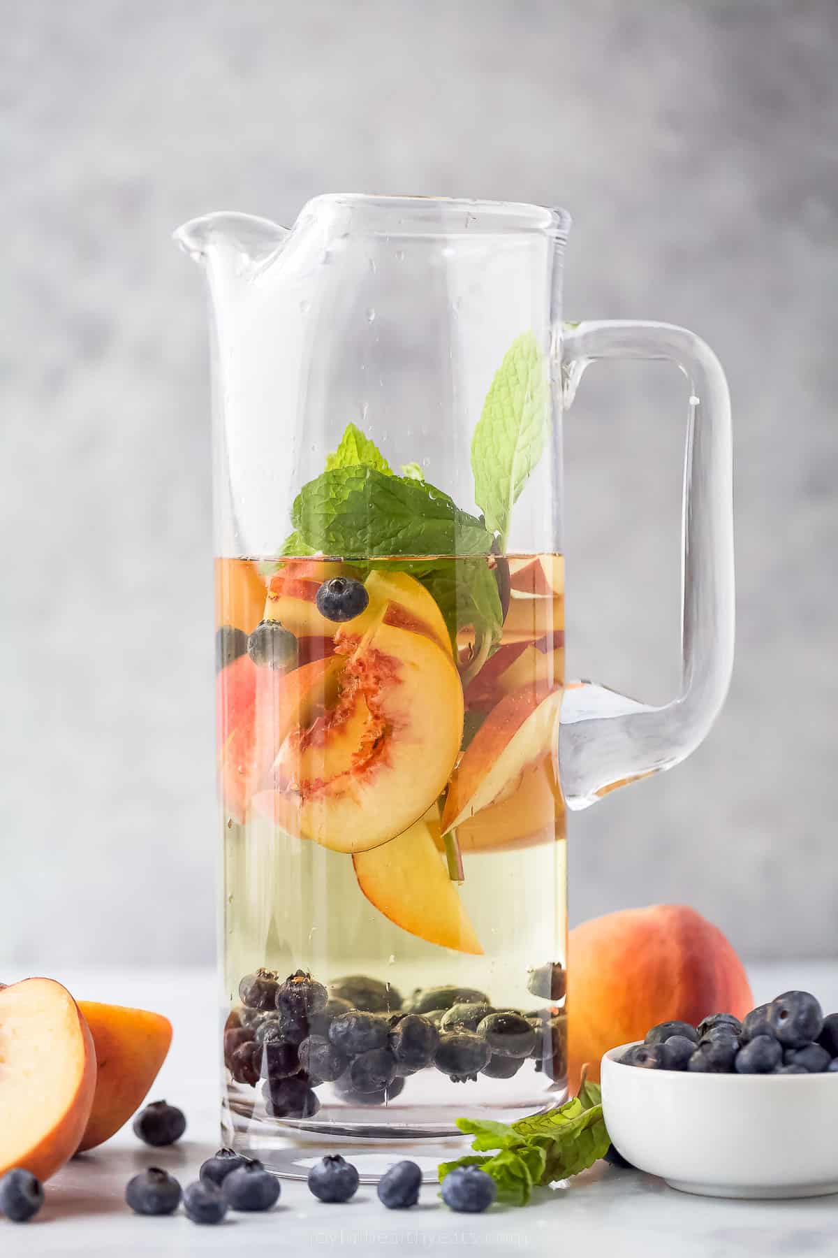 This icy peach sangria with blueberries, peach Schnapps, and mint is the fruity cocktail you'll be sipping on all summer. Pitcher of peach sangria.