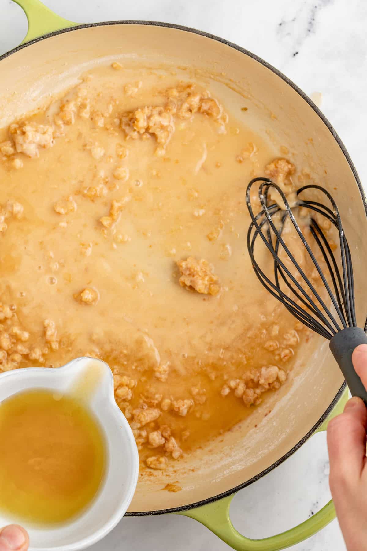 Whisking the browned flour into the melted butter.