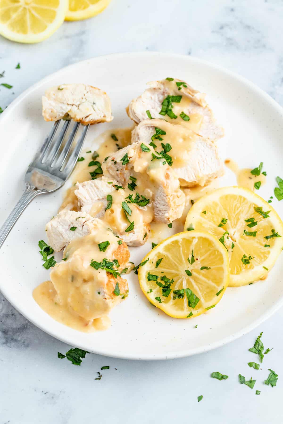 Sliced lemon chicken on a plate. 