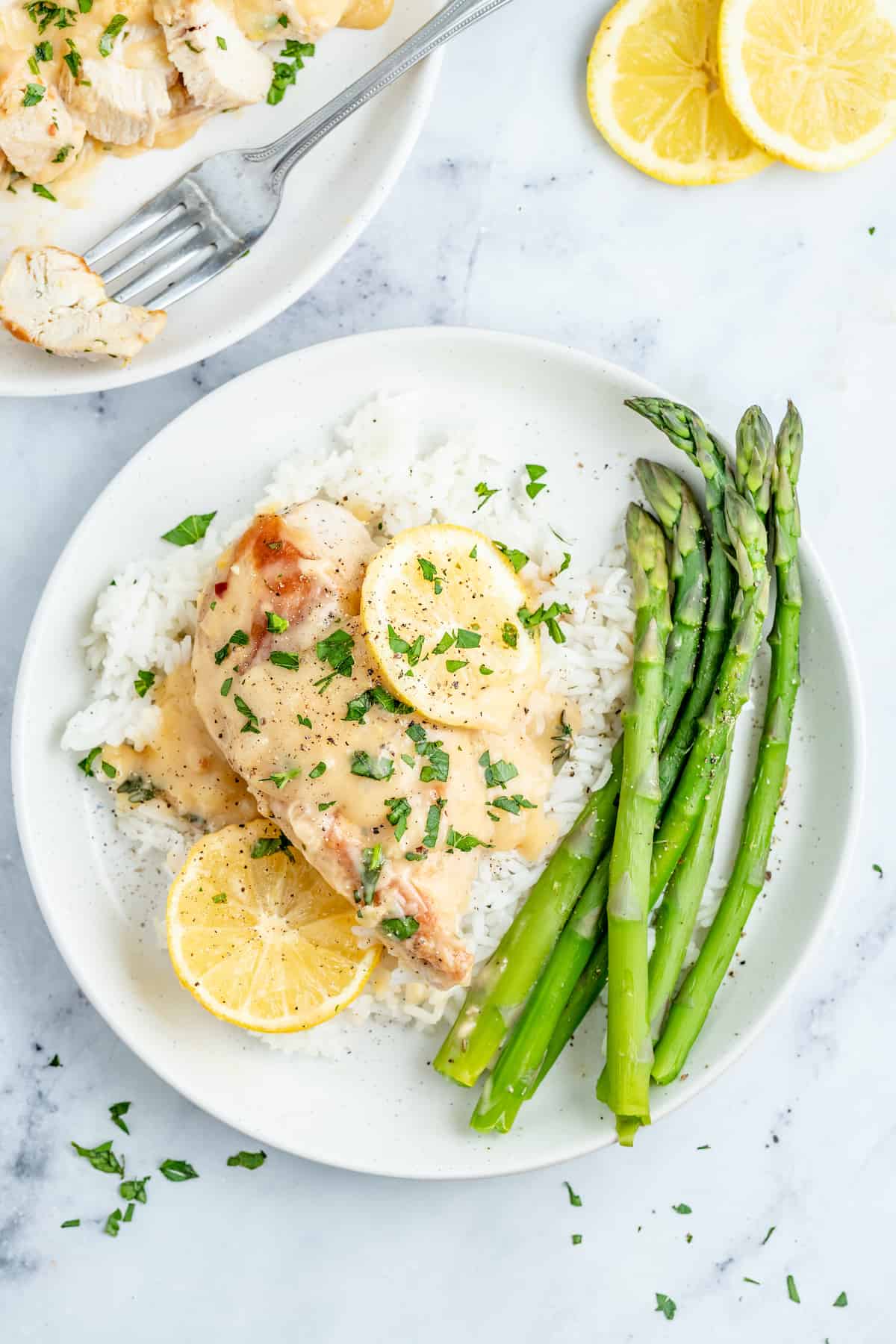 Lemon chicken with white rice and asparagus on the side. 