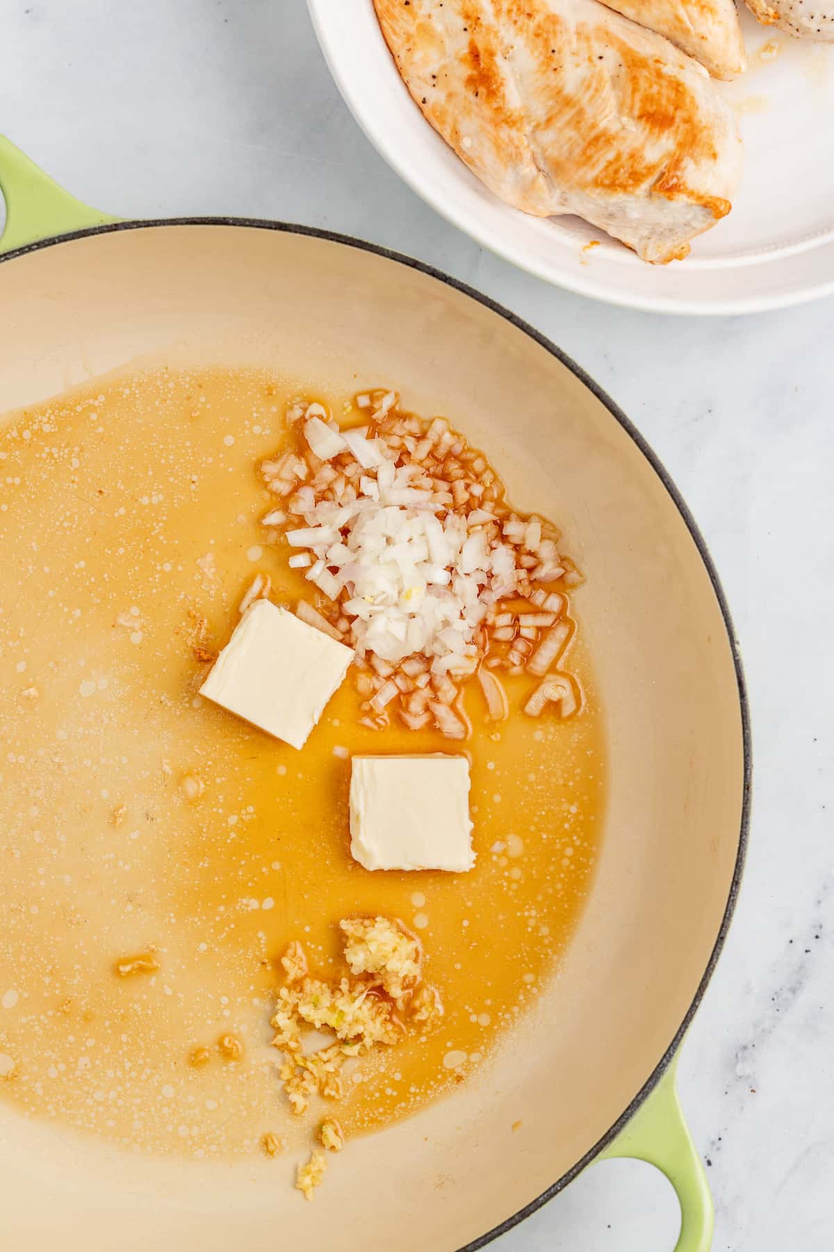 Melting the butter in the pan. 