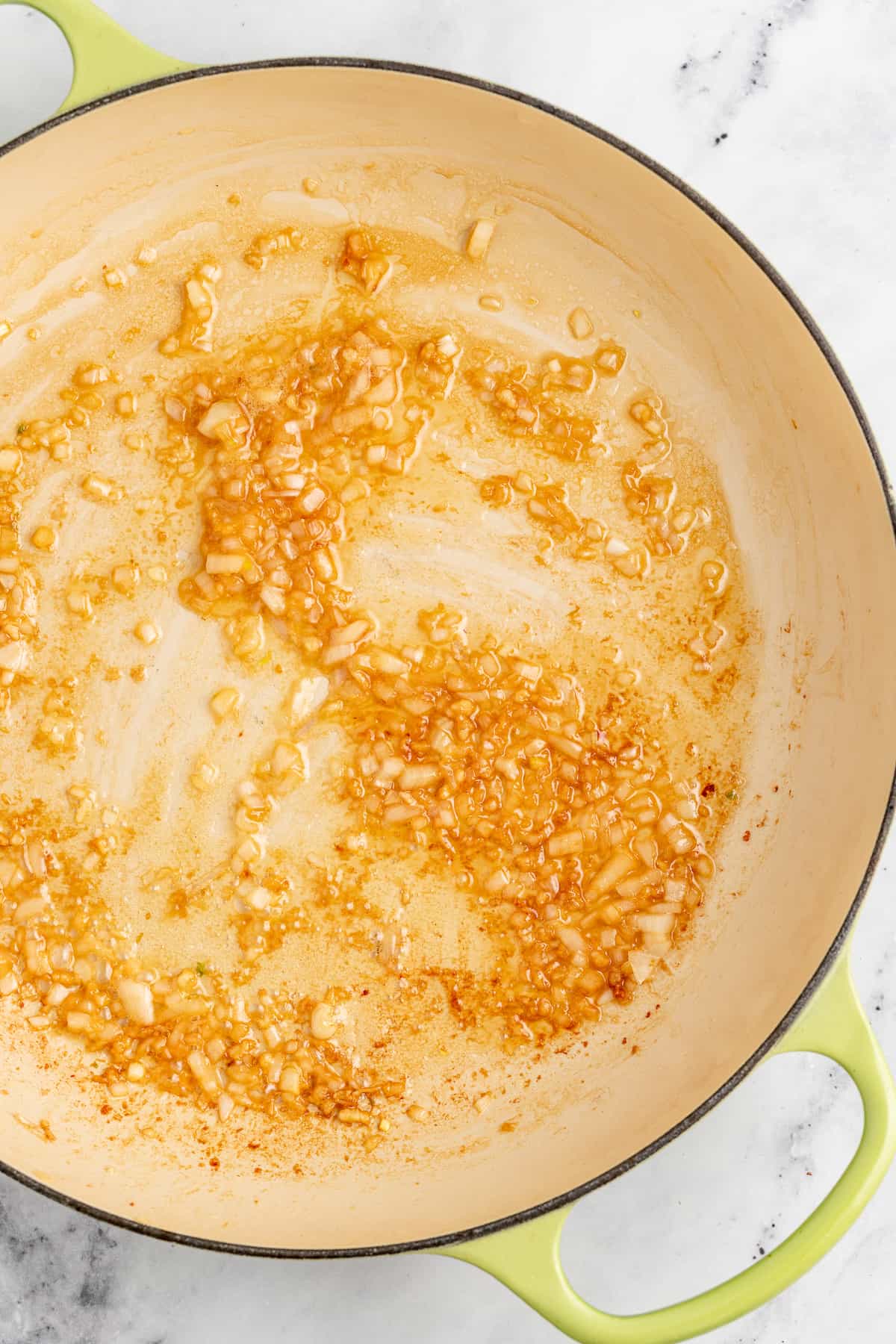 Cooking the garlic and shallots in the melted butter.