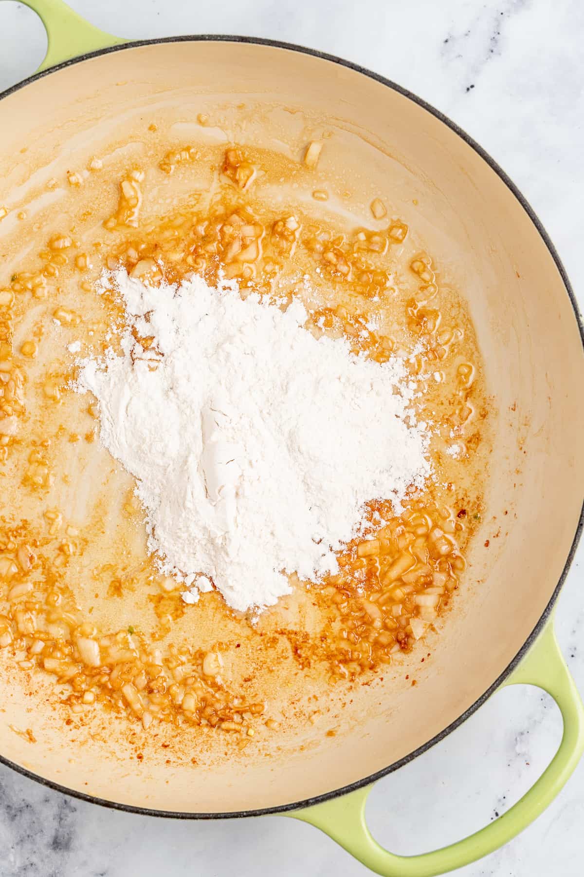 Adding the flour to the melted butter mixture.