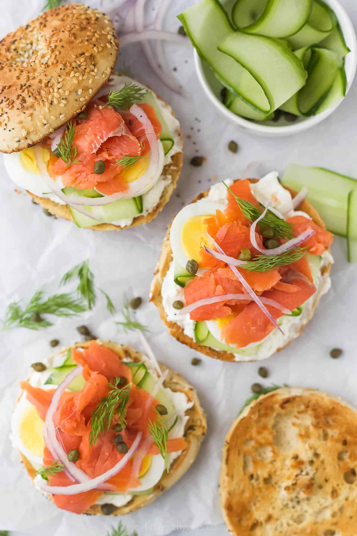 Toasted, open bagels and lox. 