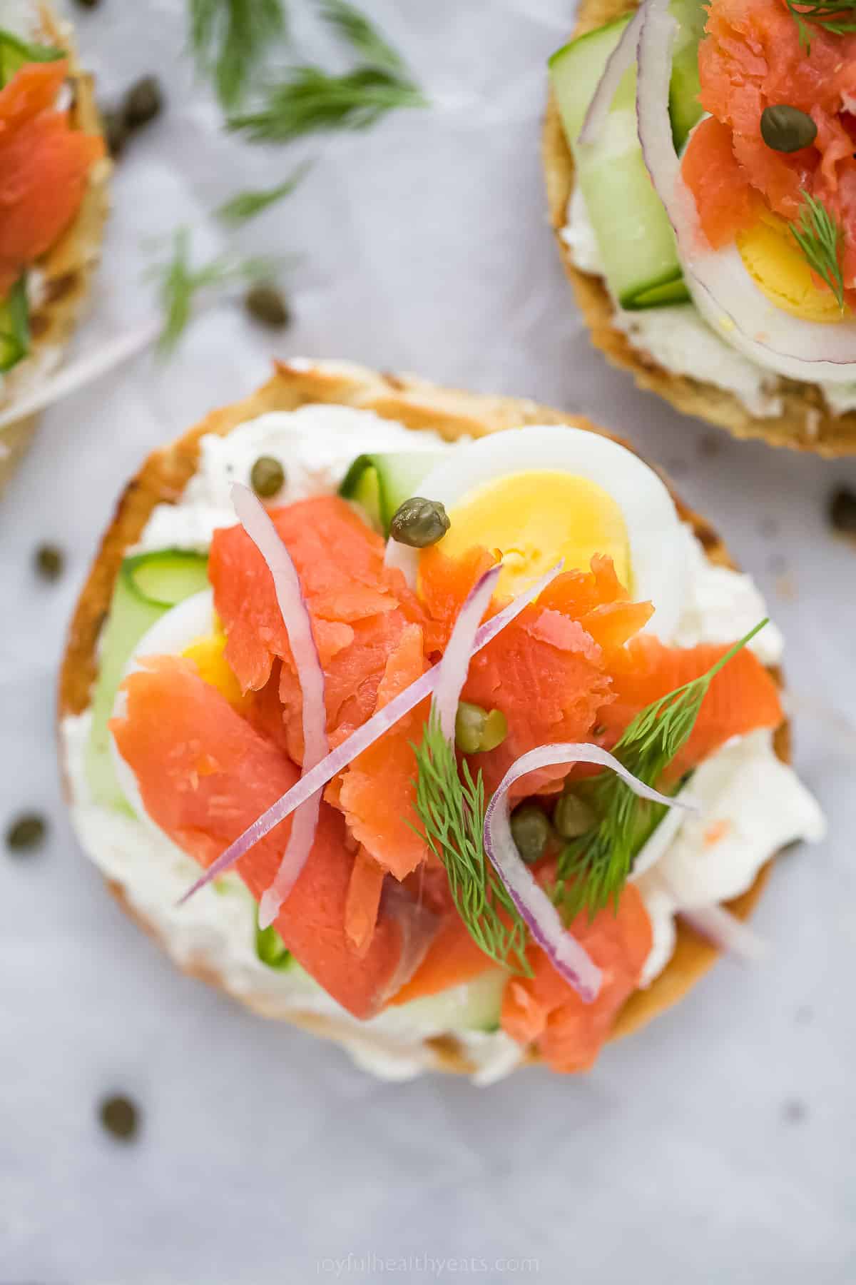 Topped with cream cheese, this bagel and lox recipe is the perfect 5-minute breakfast. It's crunchy, savory, spicy, and packed with veggies! Open bagel and lox with capers.