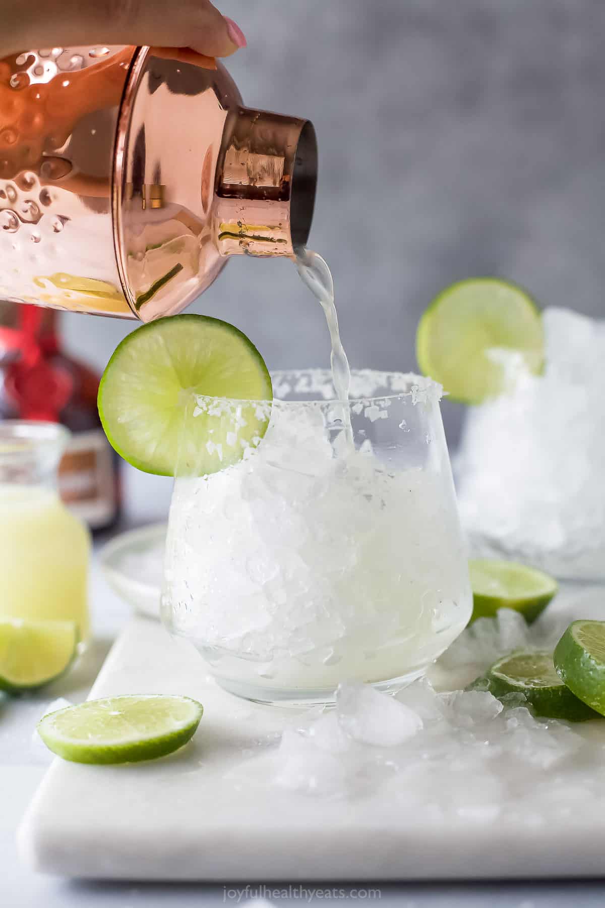 Pouring the cocktail into the glass.