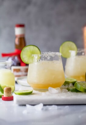 Cadillac margarita with ice and a lime wedge.