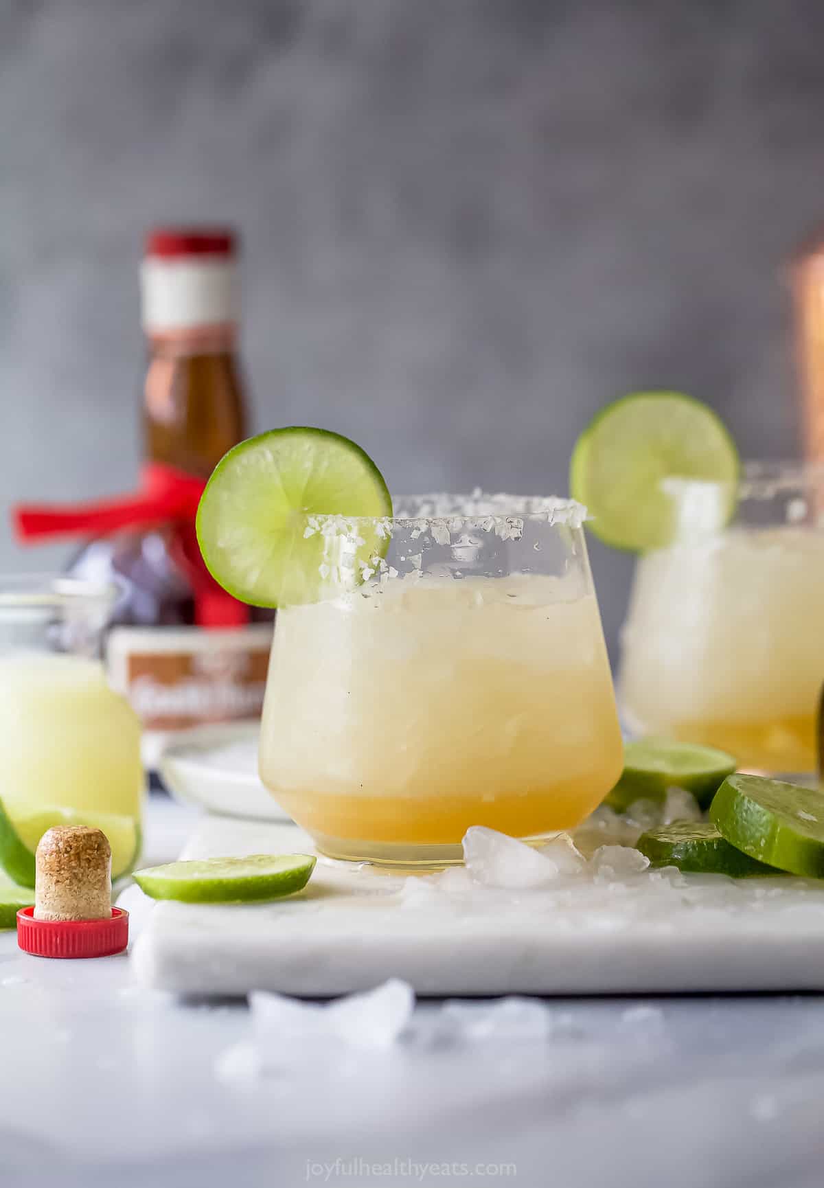This 5-minute icy cadillac margarita is packed with tequila, cointreau, and grand marnier for a refreshing summer cocktail. Cadillac margarita with ice and a lime wedge.