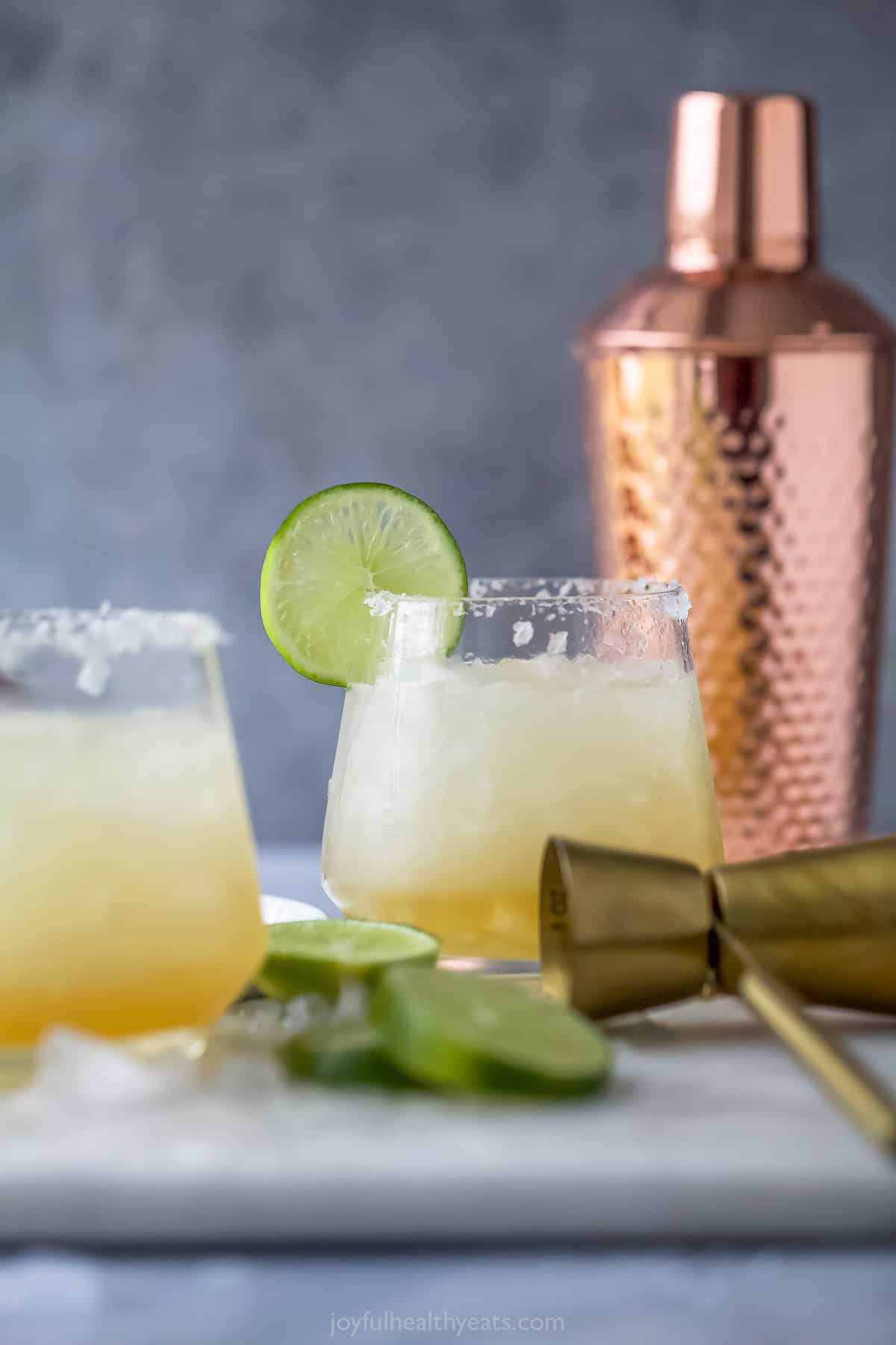 Cadillac margaritas with a cocktail shaker in the background. 