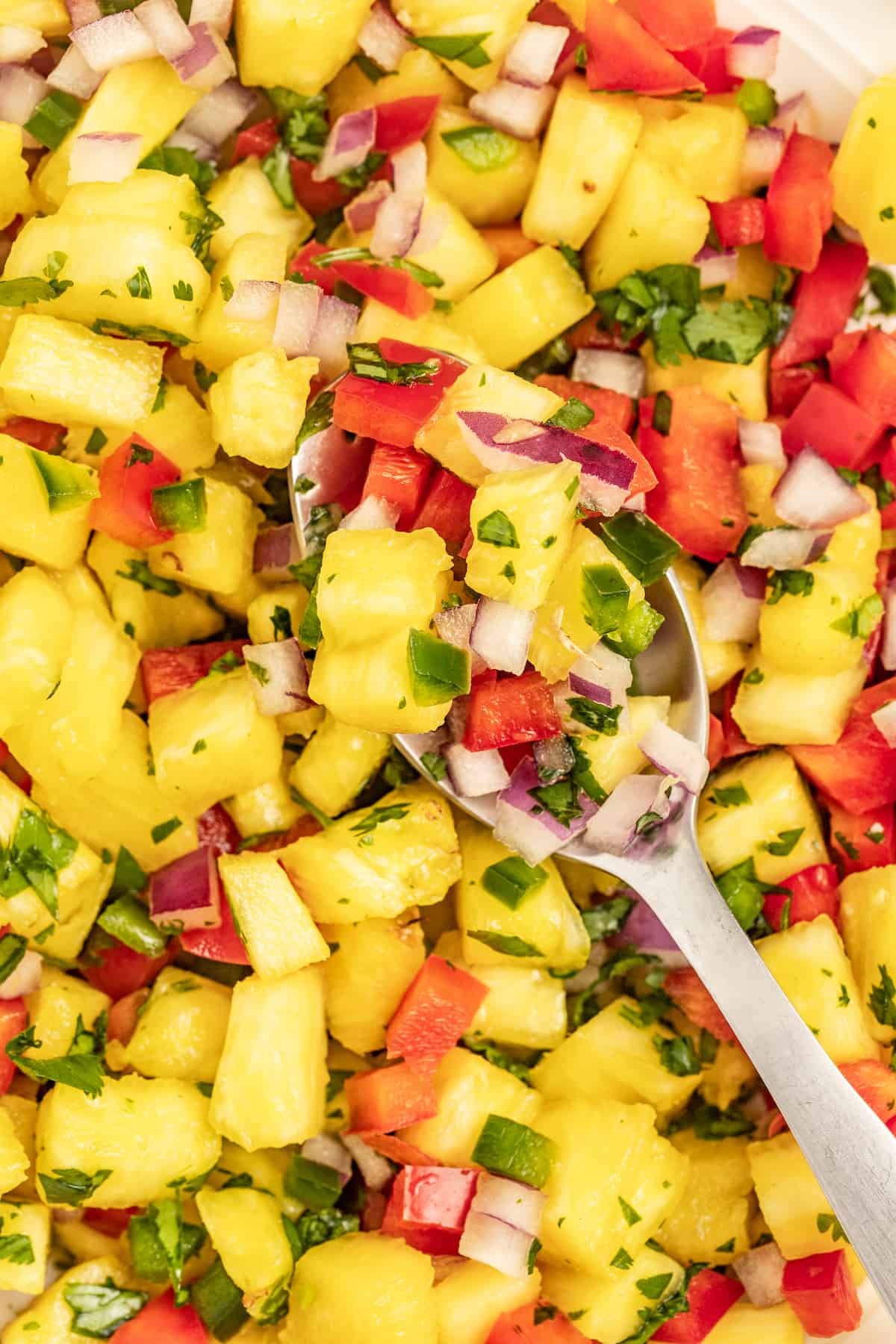 With bell pepper and jalapeño, this 15-minute pineapple salsa is a tangy, fruity, and crunchy addition to your all your meals. Close-up of pineapple salsa.