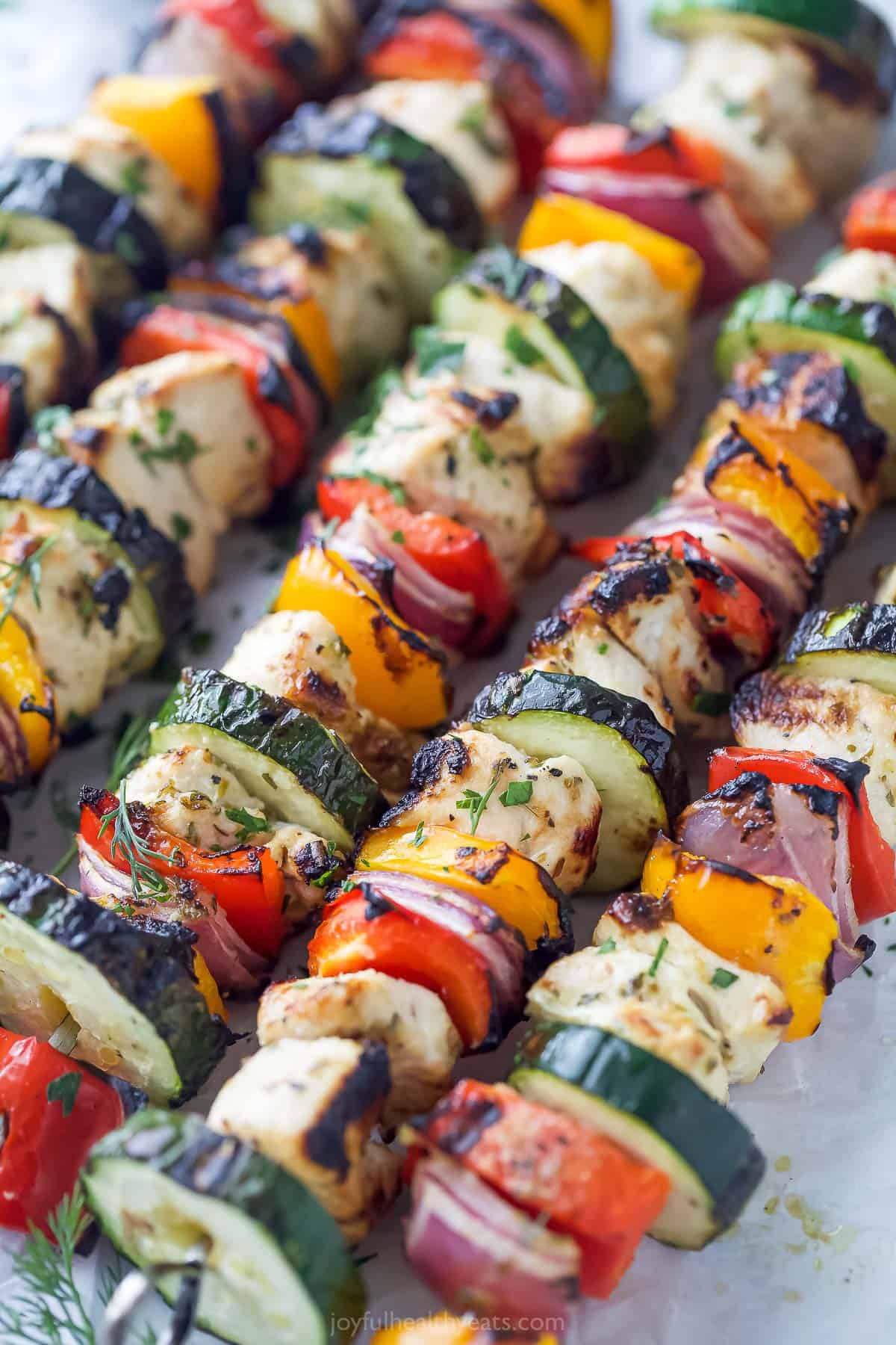 Angled photo of grilled chicken kabobs. 