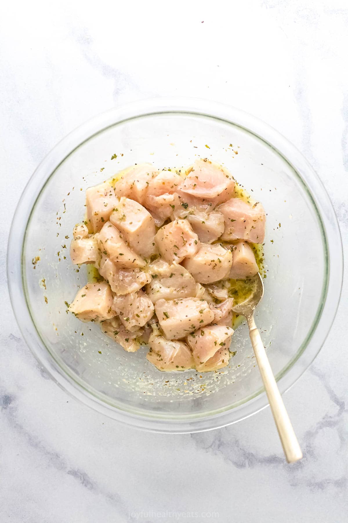 Stirring the chicken into the marinade.