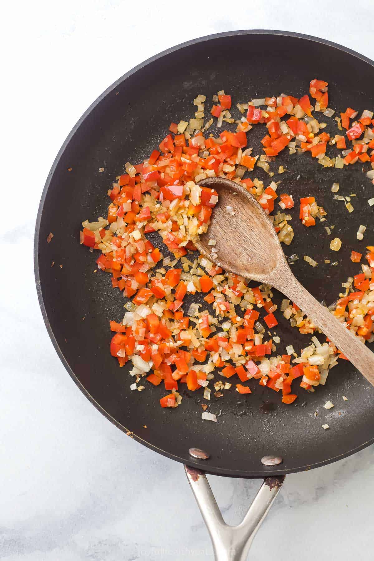 Cooked shallots, garlic, and pepper in the pan. 