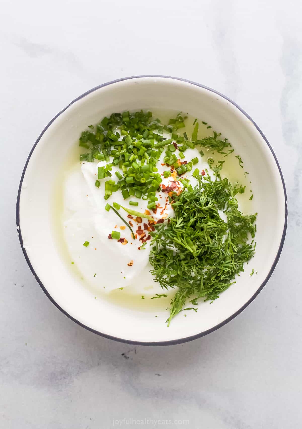 Lemon yogurt dill sauce ingredients in a bowl. 