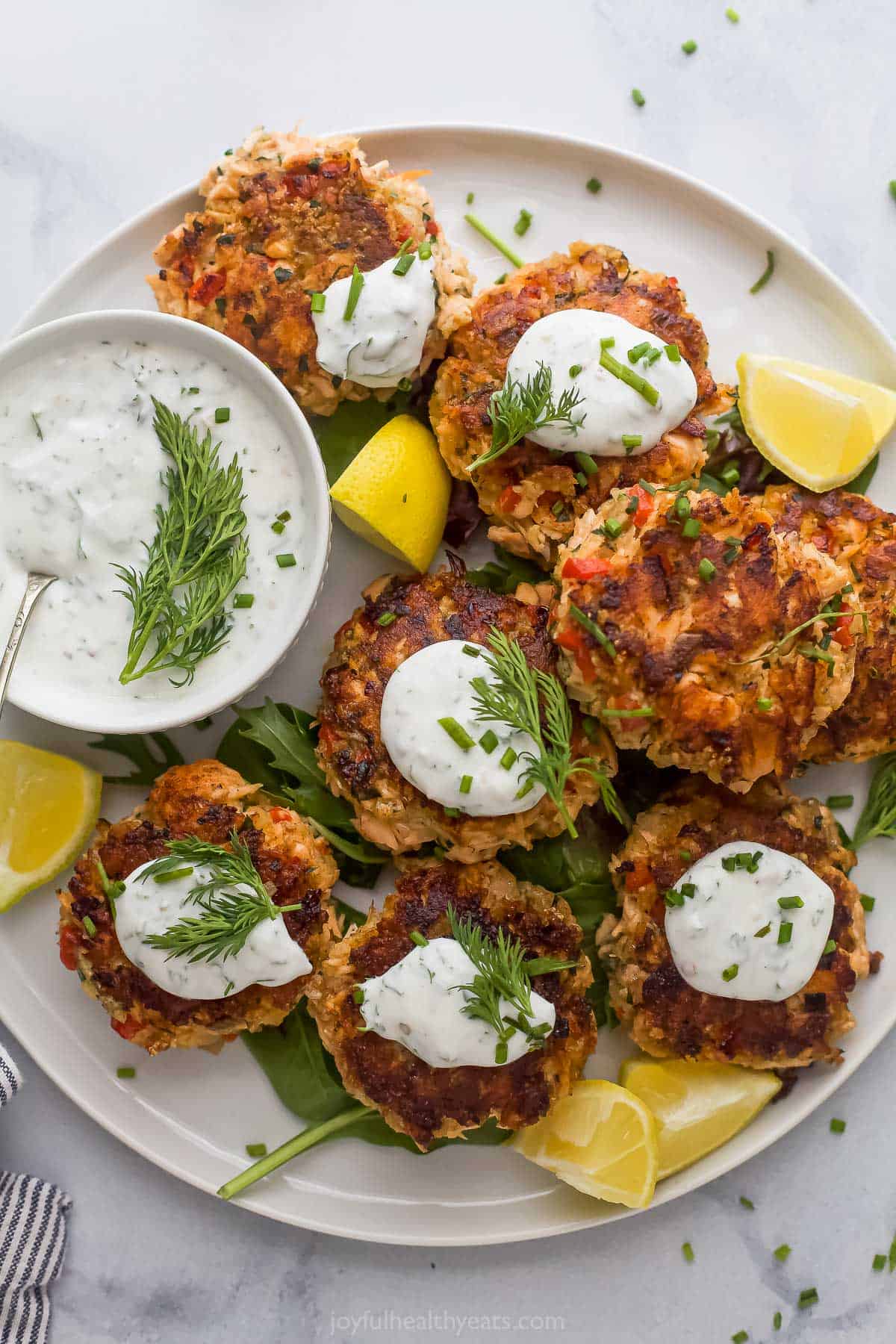 Salmon cakes with lemon dill sauce on the side. 