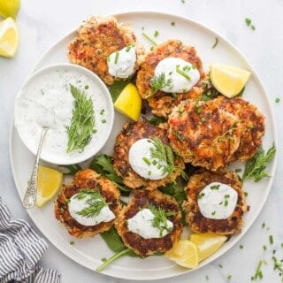 Salmon cakes with lemon dill sauce on the side.
