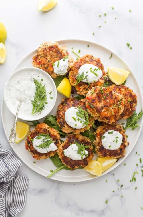 Salmon cakes with lemon dill sauce on the side.