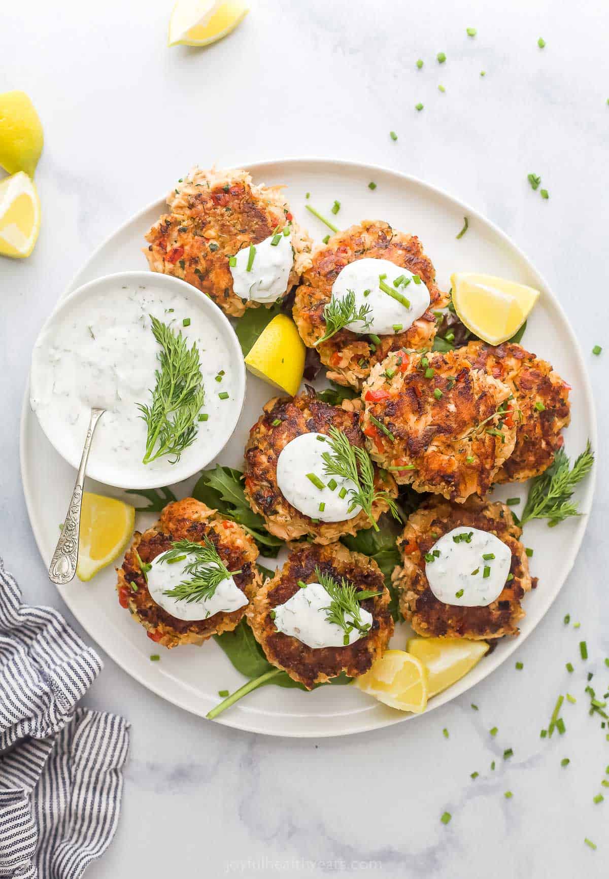 Salmon cakes with lemon dill sauce on the side.