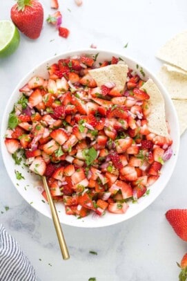 Strawberry salsa in a bowl with corn chips.