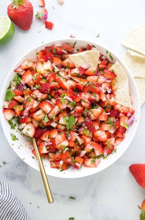 Strawberry salsa in a bowl with corn chips.