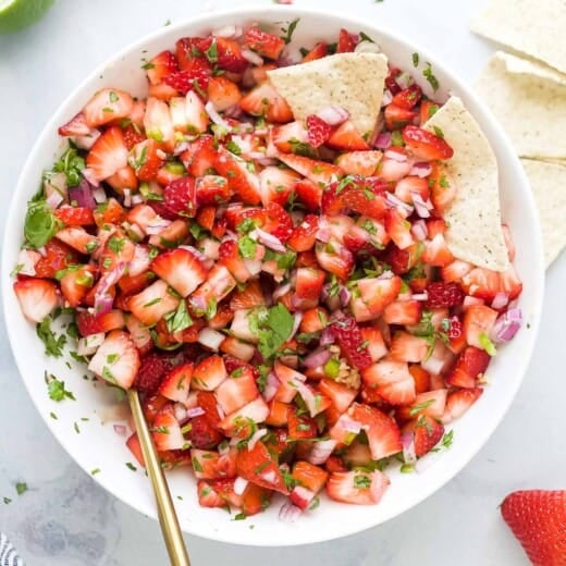 Strawberry salsa in a bowl with corn chips.