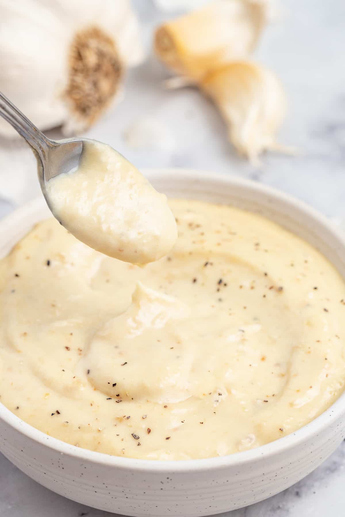 A spoonful of thick, creamy garlic aioli.