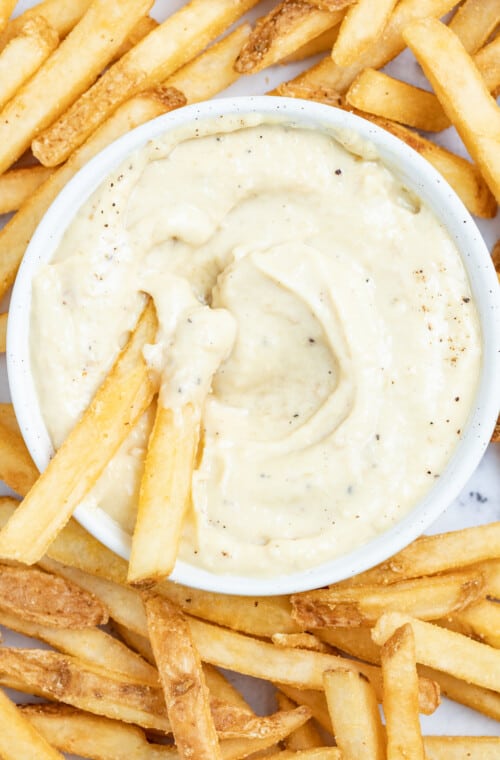 Dipping french fries into aioli.