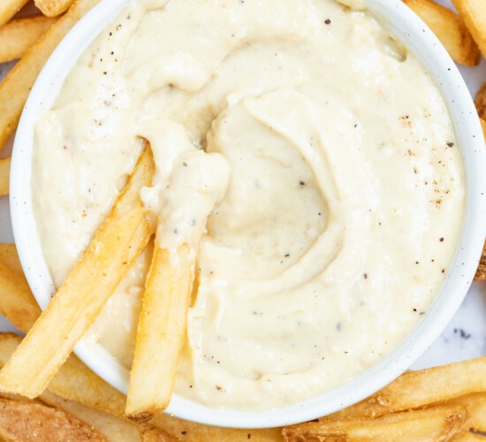 Dipping french fries into aioli.