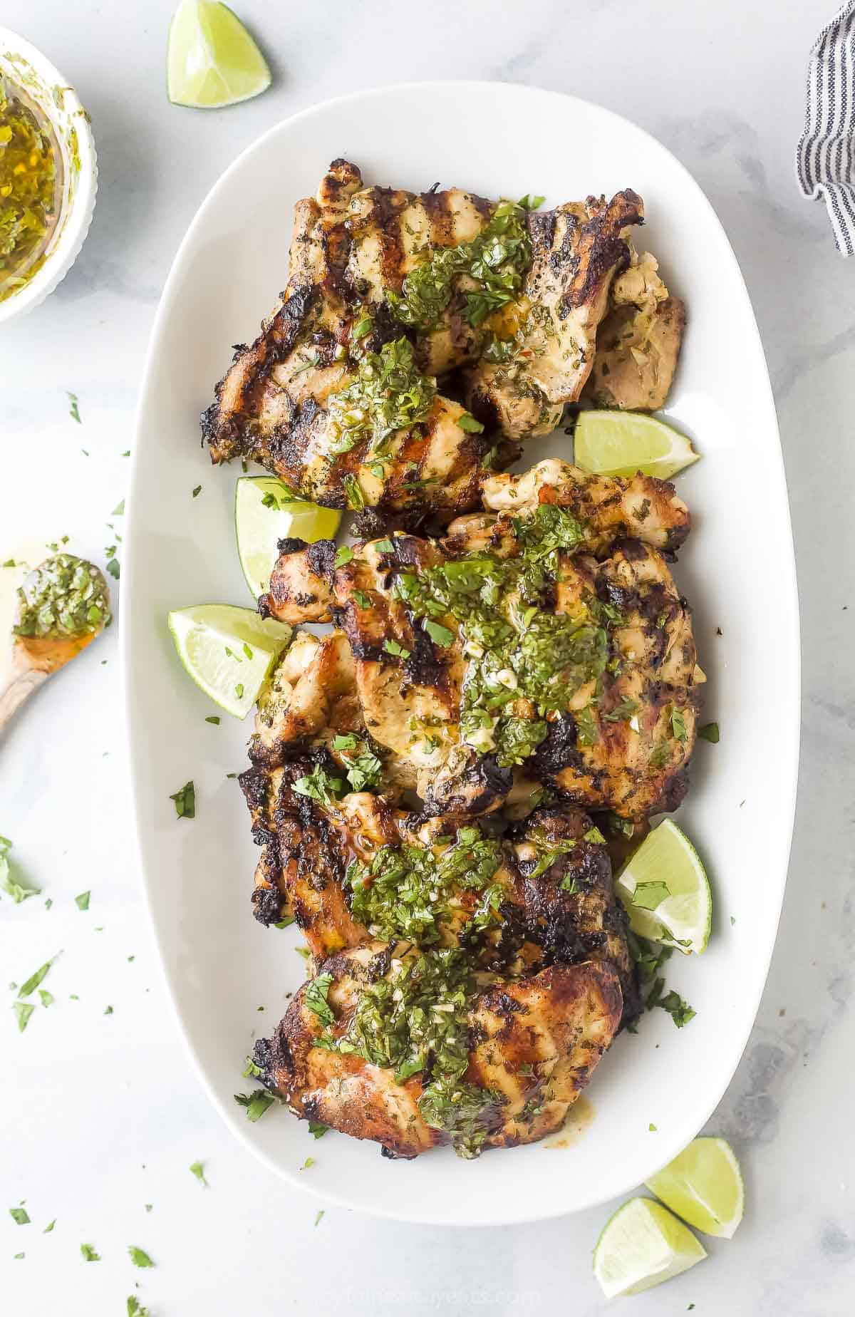 Chimichurri chicken with grill marks on a plate. 