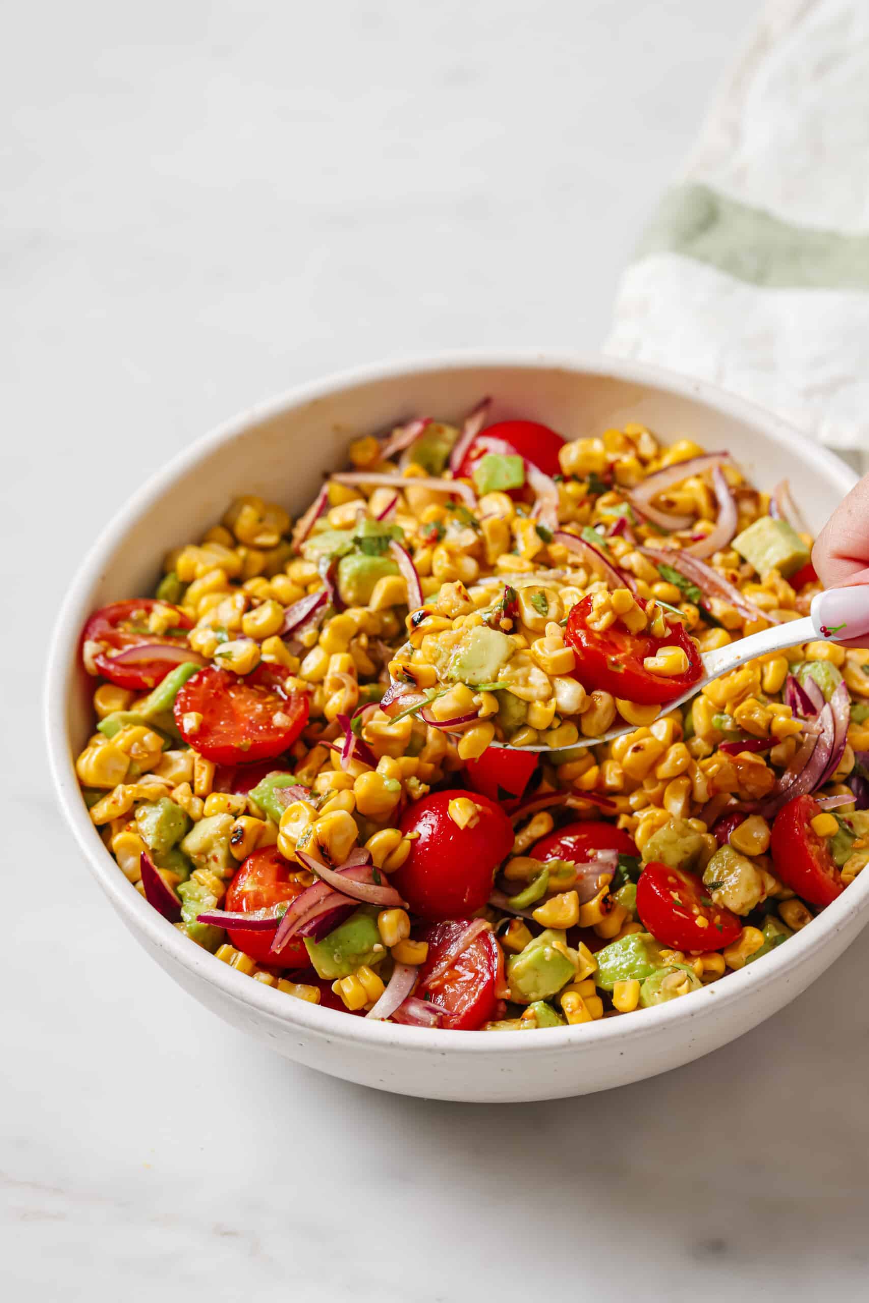 Bowl of grilled corn salad with homemade dressing. 