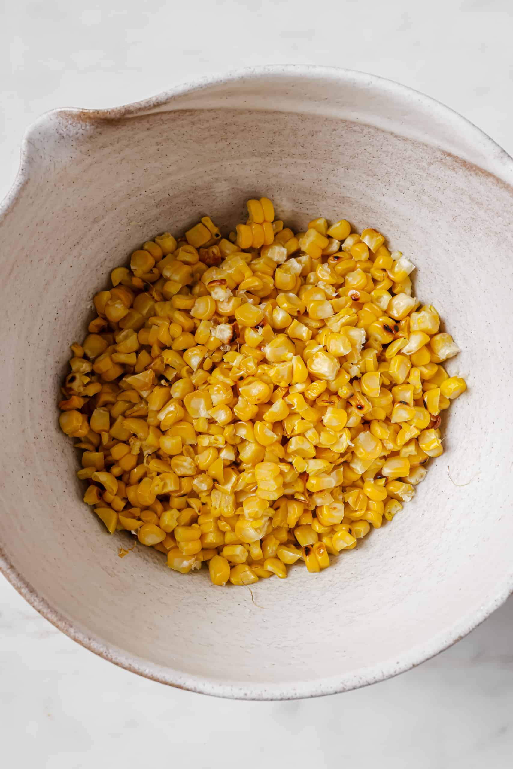 Placing the corn kernels in a bowl.